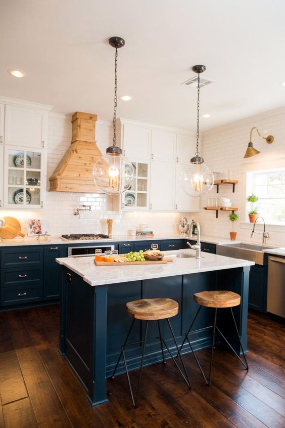 dark blue kitchen cabinets with marble countertops and suspended white cabinets