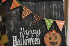 21 a black shabby rustic sign with a colorful banner, a burlap pumpkin applique and Happy Halloween words