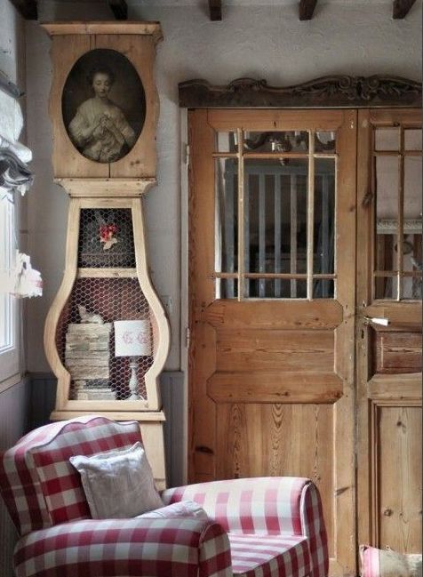 a grandfather's clock used for storage and to display a portrait