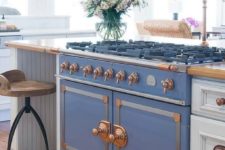 21 a retro French stove in blue with copper touches makes a gorgeous statement
