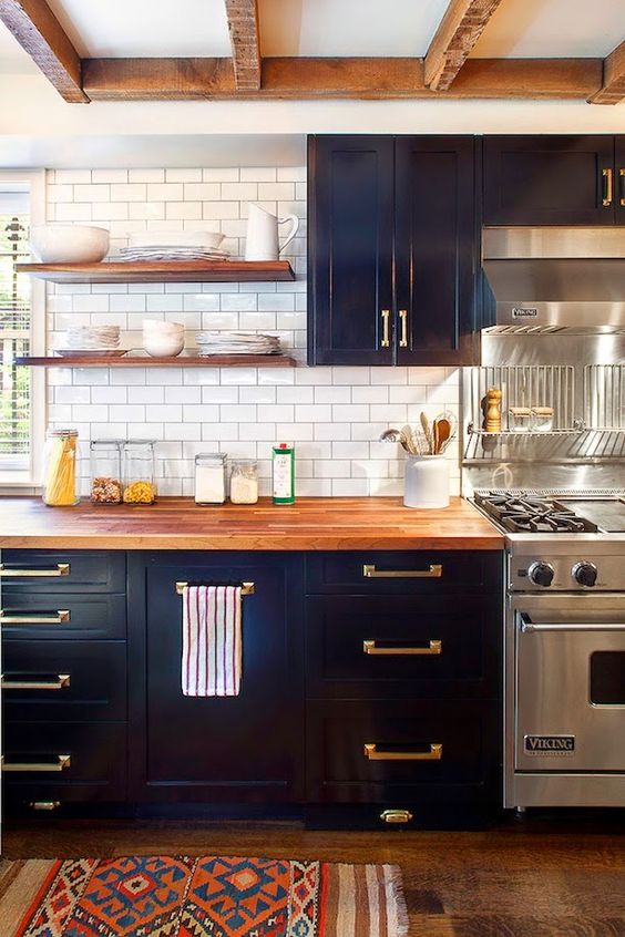 dark navy cabinets and wooden countertops for a contrast