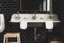 21 glossy black tiles with white grout for a vintage-inspired bathroom