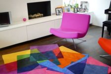 22 a colorful geo rug and a hot pink chair for a modern cheerful living room
