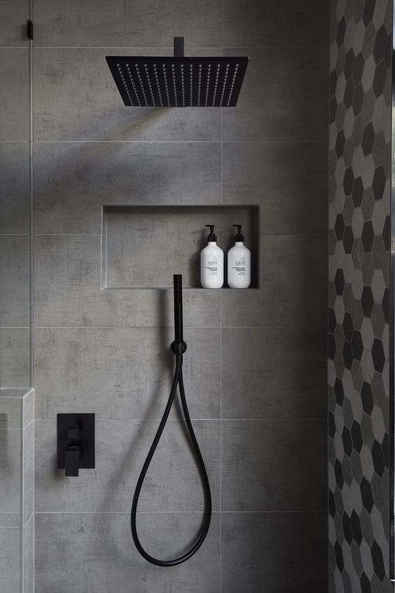 matte grey tiles in the shower and hex shaped ones in grey shades for an accent wall
