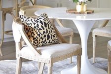 25 a neutral and chic dining space with a cheetah print pillow and a cow skin rug