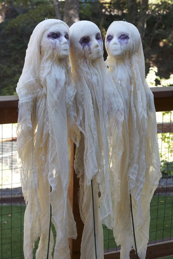 scary cheesecloth ghosts with human-like faces decorated with ink are great for outdoors