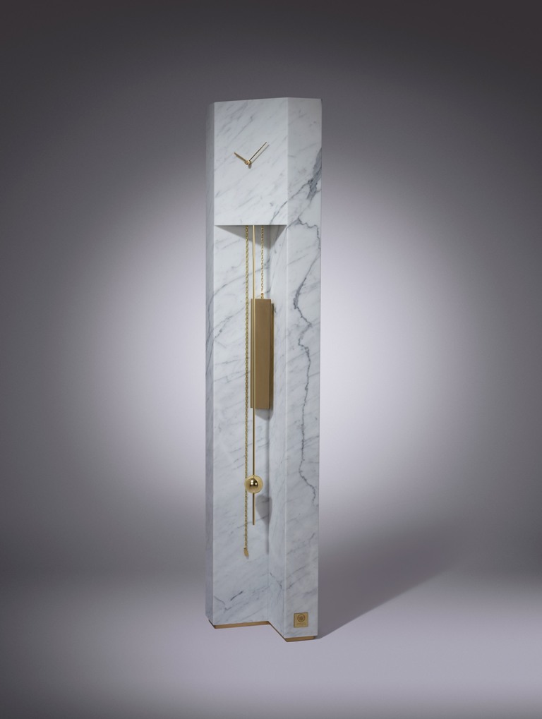 a luxurious version of a grandfather's clock of white marble and brass
