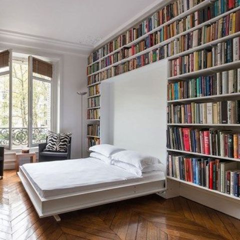 make a guest bedroom in the library creating bookshelf walls with a murphy bed