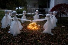 26 scary children ghosts dancing around the fire are made of white tulle and wire