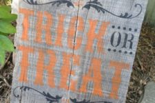 27 a simple pallet sign with black prints, and orange Trick or Treat letters