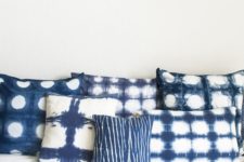 28 shibori dyed pillows and matching wall arts on the wall will make your bedroom heavenly