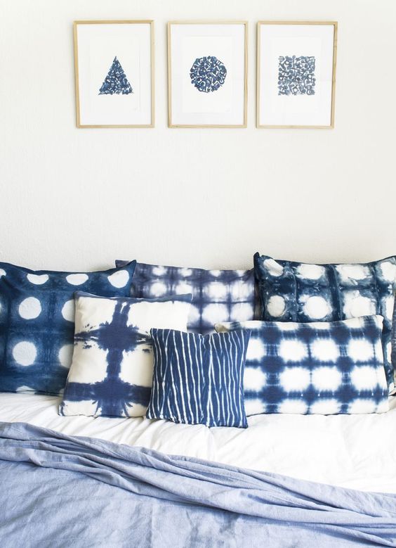 shibori dyed pillows and matching wall arts on the wall will make your bedroom heavenly