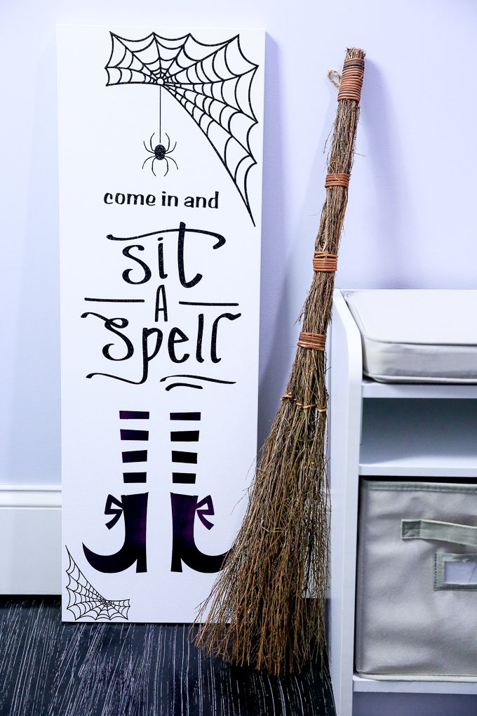 an easy to make witch-themed sign on a canvas could welcome your guests before dinner