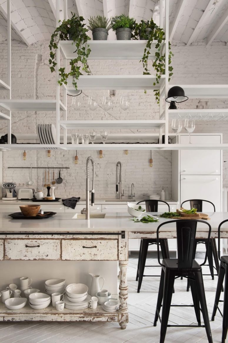 This Barcelona loft features many vintage and shabby chic features and looks very relaxing, here's the kitchen with whitewashed brick and whitewashed shabby chic furniture