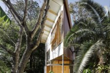 01 This garden house was built in treehouse style and it features a pointed design with several spaces inside