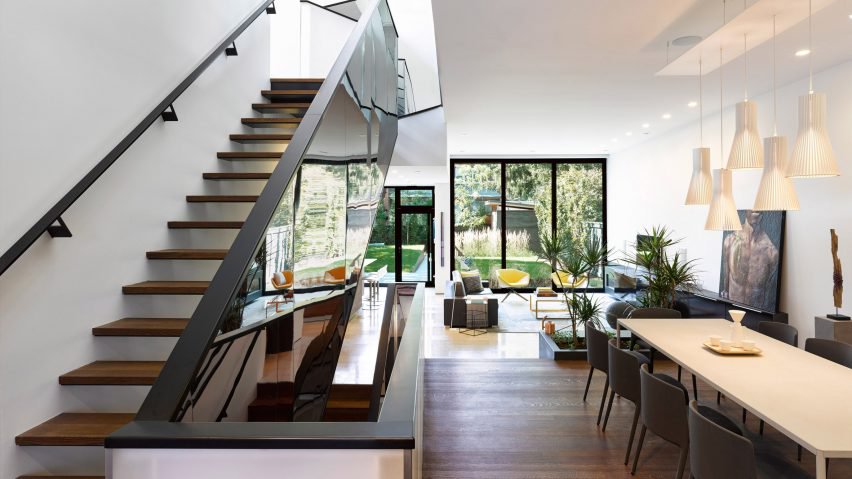 This modern suburban hosue features a unique thing   a mirrored staircase that reflects the light and makes the rooms look bigger