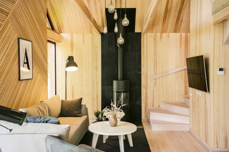 A lot of light-colored wood was used for decor, and it's clad in different eye-catchy ways, black touches like this hearth help it stand out