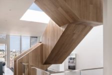 02 A sculptural staircase made of wood goes through all the floors and makes a statement