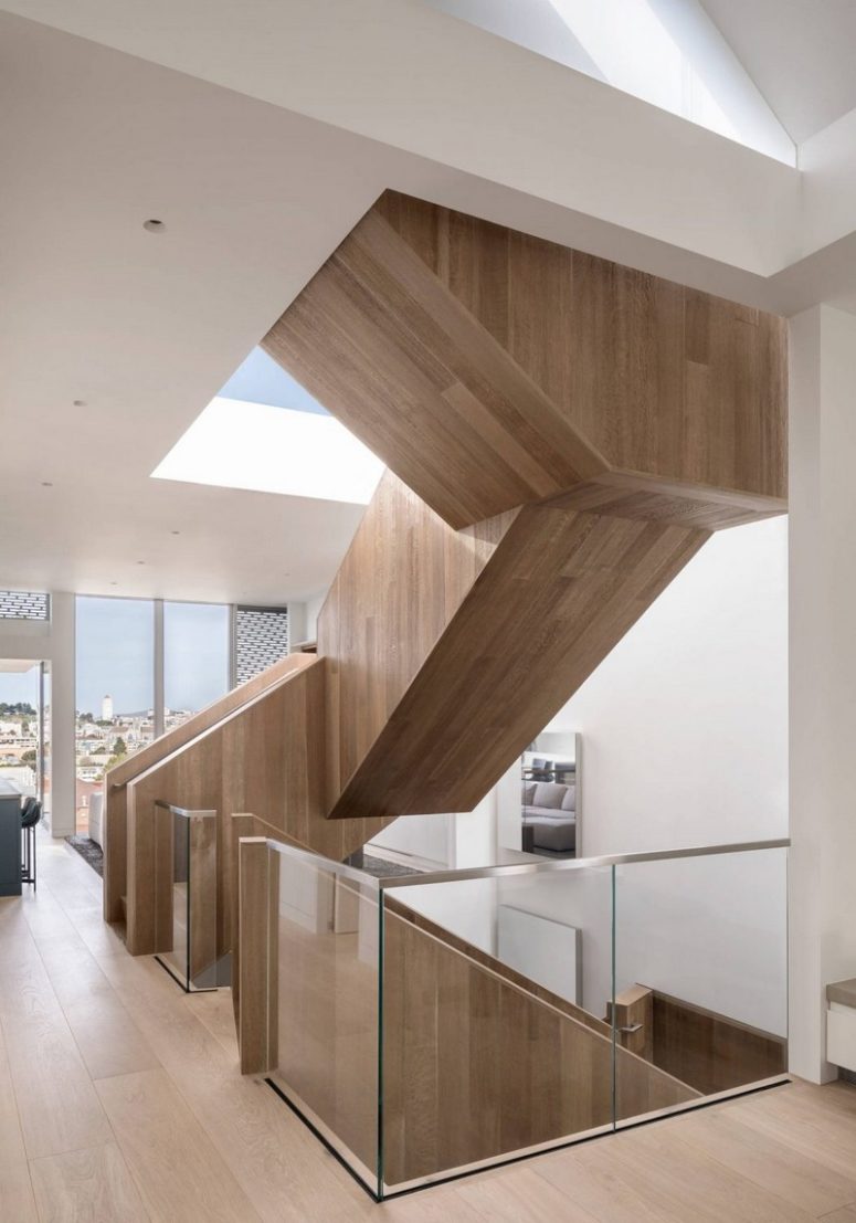 A sculptural staircase made of wood goes through all the floors and makes a statement