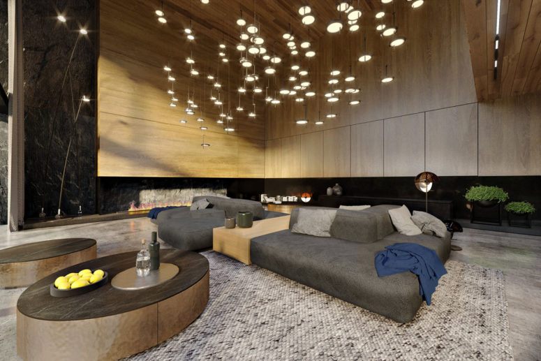 Most of the living room is clad with oak, there are modern sofas, stone clad tables and unconventional lighting