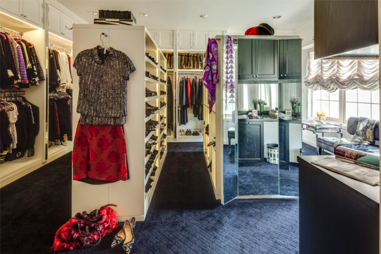 The mirror is attached to the side of one of the shelving units, and there's a couch by the window, you can also see an accessory table