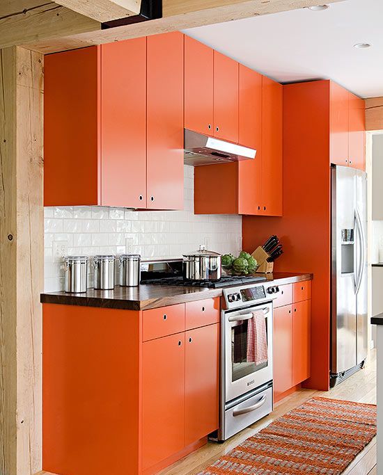 a bold orange kitchen with a simple modern design looks cheerful and fun