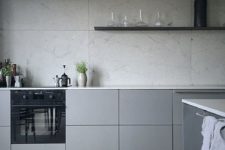 02 a minimalist grey kitchen with a grey marble backsplash and white countertops for a fresh touch