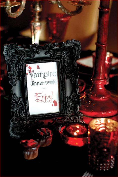 a stylish black framed sign, dark red and black decorations around