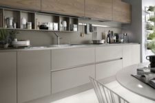 03 a grey kitchen with wooden cabinets and a grey backsplash, with built-in shelves and nickel touches looks very modern