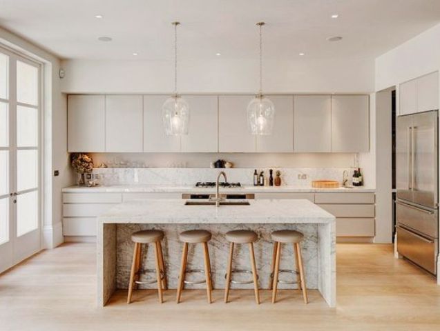 Cream Marble Kitchen Islanad a neutral kitchen with cream cabinets a white kitchen island with marble touches and pendant