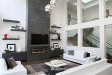 04 a neutral space is highlighted with dark floors and a dark concrete fireplace, bubble lights add interest