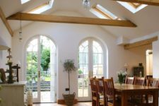 04 a vaulted ceiling with skylights and wooden beams brings a rustic feel and light in
