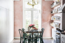 04 a vintage-inspired kitchen and dining zone with a pink wall looks very cute