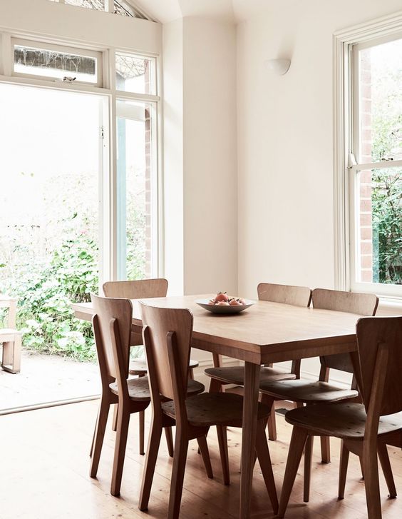 The dining space is filled with light from a little courtyard and features a simple dining set