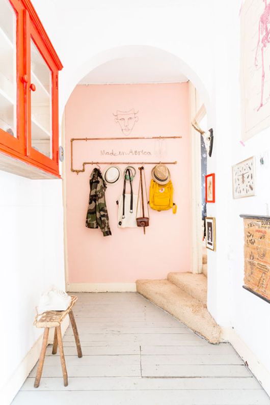 a pop of pink here creates a soft and sweet look in this entryway