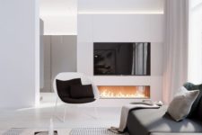05 an elegant space with a graphite grey sofa, a built-in fireplace and lots of white color