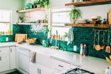 05 an emerald tile backsplash is a colorful and bright feature in this light-colored kitchen