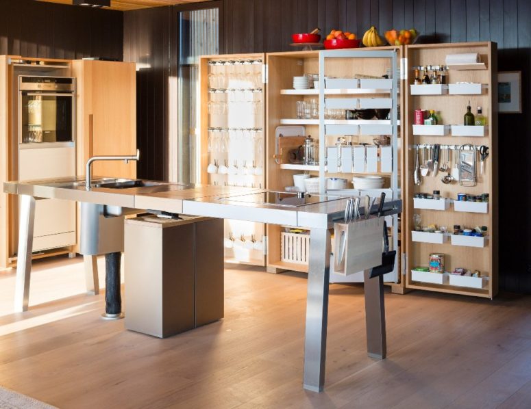 This is a kitchen with a modern metal kitchen island and comfortable cabinets also done in wood