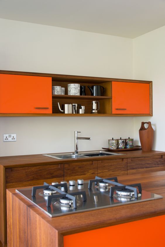 saturated natural wood looks chic with bold orange surfaces in this modern space