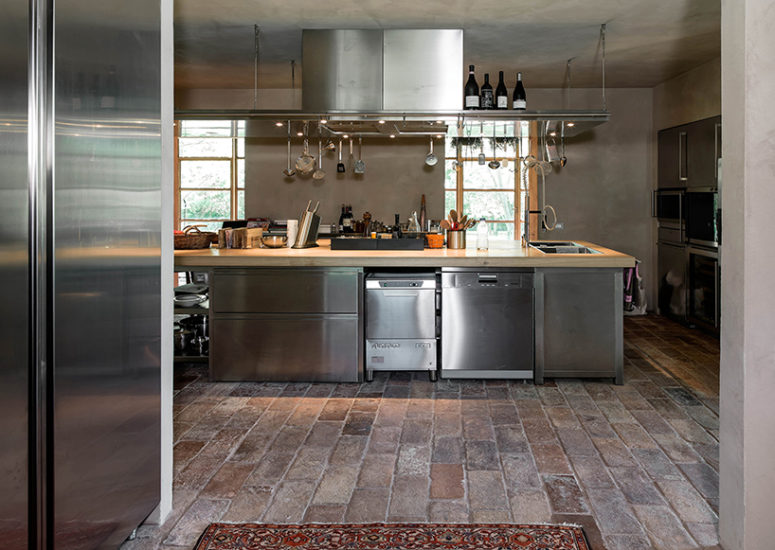 The kitchen is stainless steel, with concrete and brick floors, which altogether create a cool industrial feel The kitchen is stainless steel, with concrete and brick floors, which altogether create a cool industrial feel