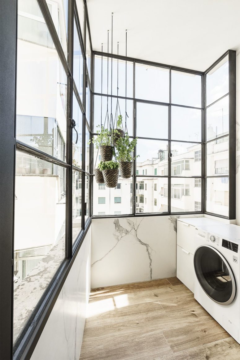 This lovely laundry room is filled with light and greenery as all the rest of the spaces