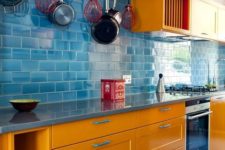 07 orange cabinets, a blue tile backsplash and floors and a red shelf for a colorful space