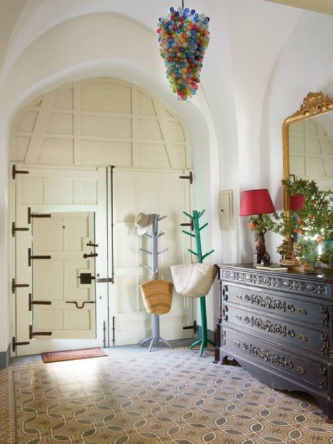 In the entrance, Italian tile floors bought in Lebanon, and a hanging glass lamp made with Syrian glass