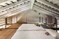 09 The attic space is used for a bedroom, where you can see only exposed wooden beams and two beds – what else do we need for a cozy nap