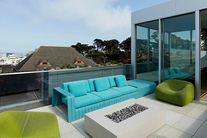The modern terrace features cool edgy furniture in turquoise and bold green