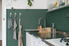 09 a half-painted dark green wall is used as a backsplash and adds a colorful accent