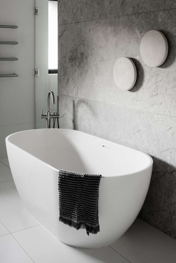 There's a free-standing bathtub and the same decor as in the bedroom to connect the spaces