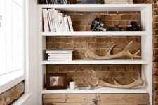 11 a modern masculine entryway with a simple antler display to highlight the manly style