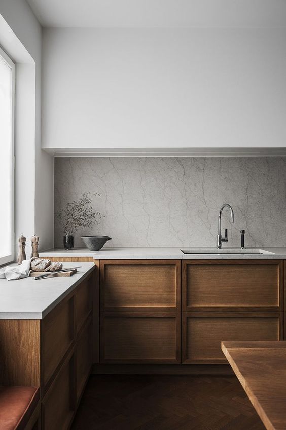 a modern space with sleek white cabinets, wooden ones and a stone backsplash for a textural look