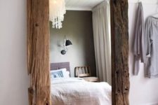 13 a large mirror with a reclaimed wood frame is a real chic statement that catches an eye and brings coziness